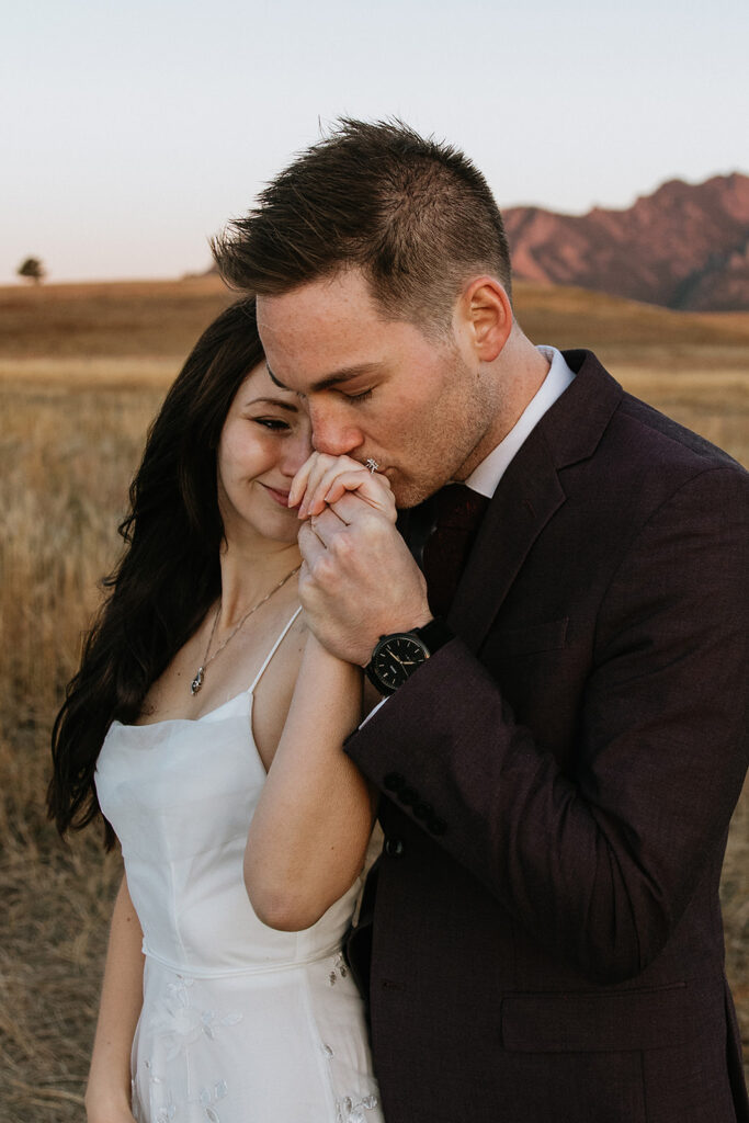 groom kissing the brides hand 