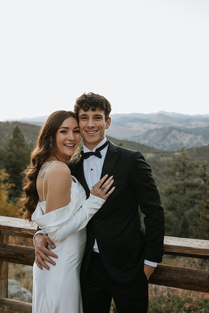 couple smiling at the camera during their bridal portraits 