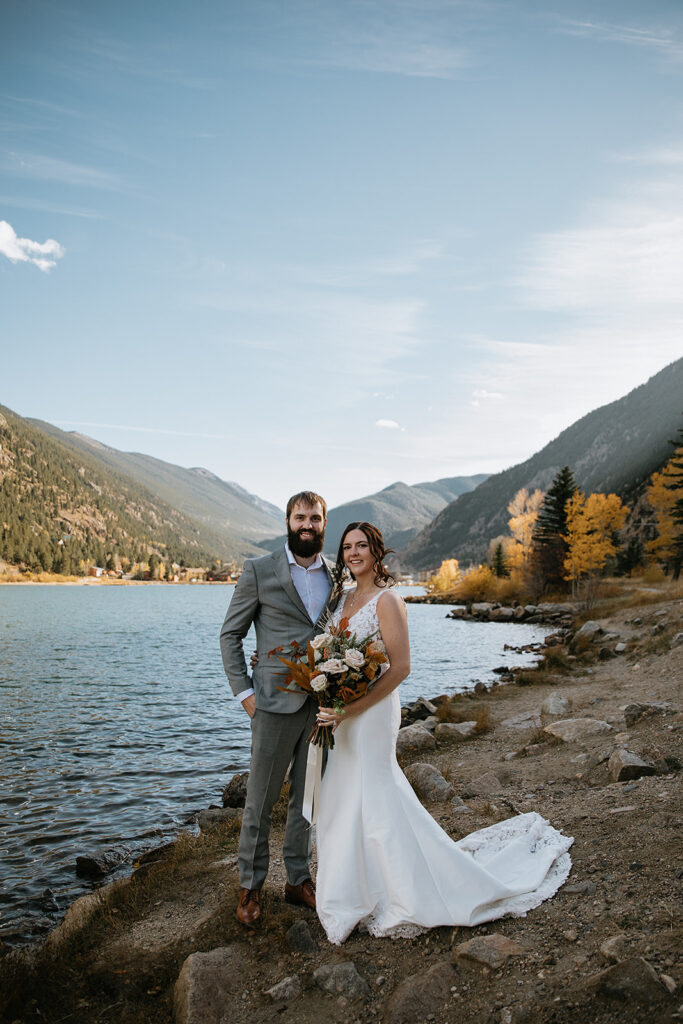 Couple smiling at the camera during their bridal portraits