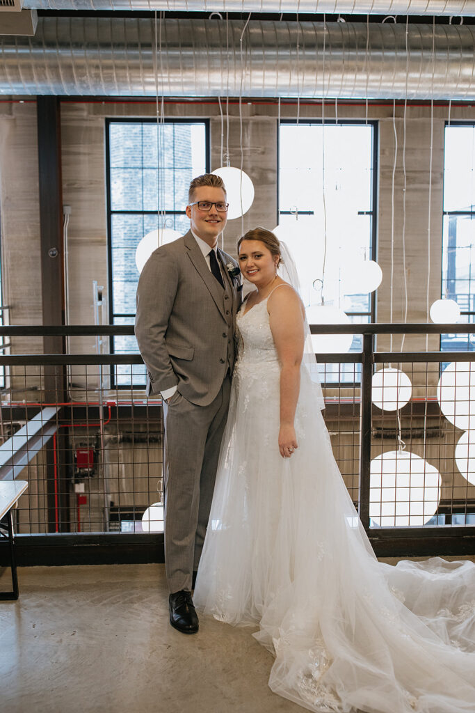 Bride and groom smiling at the camera during their bridal portraits