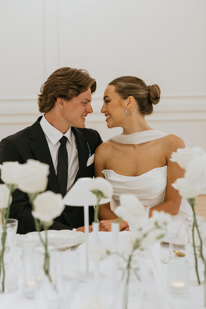 Picture of the newlyweds smiling at each other