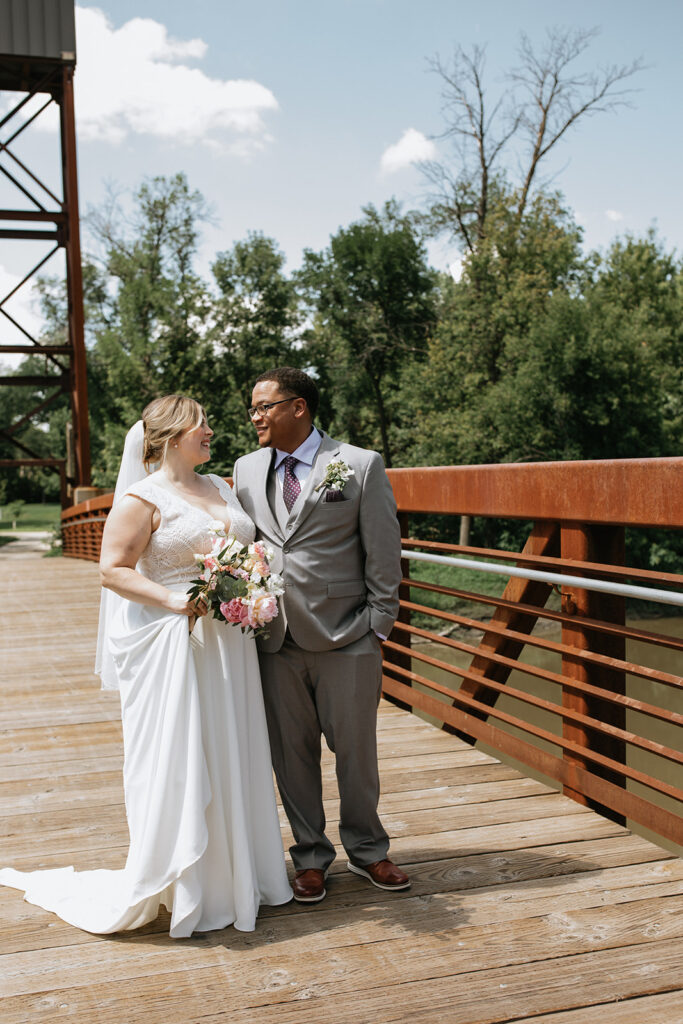 cute couple smiling at each other during their photoshoot