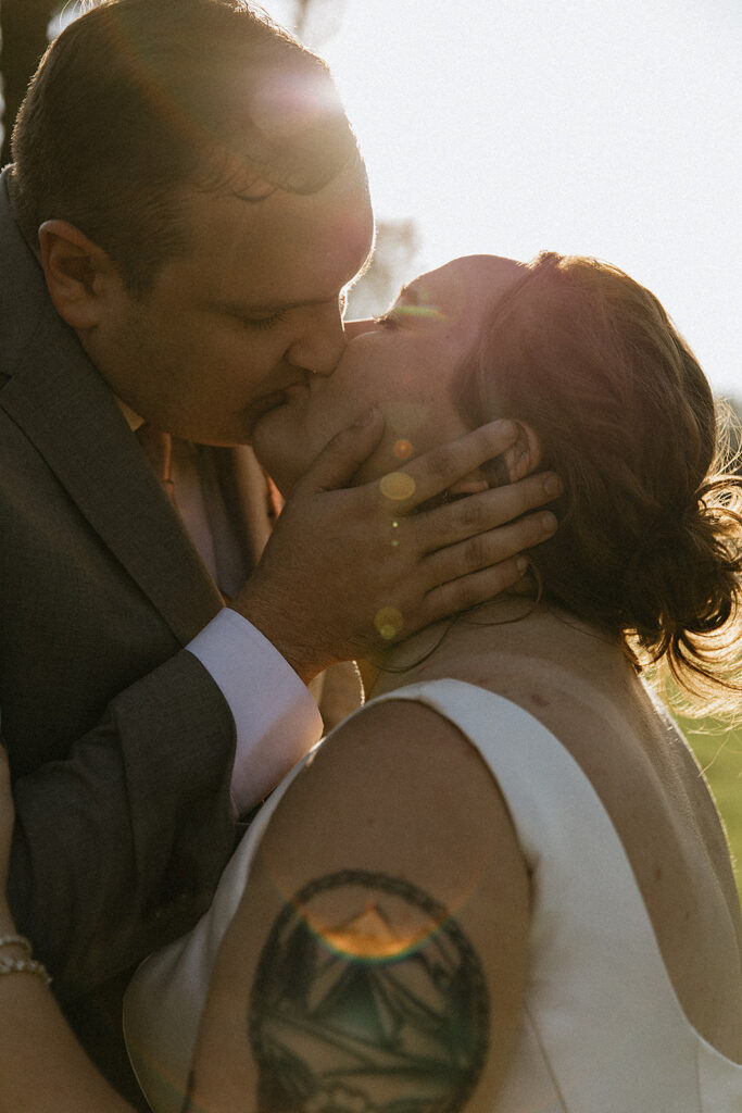 cute picture of the newlyweds kissing after their wedding ceremony