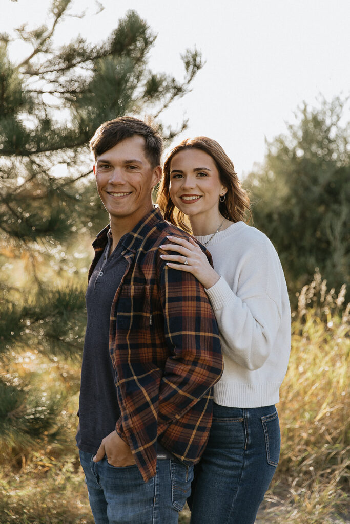 cute couple smiling at the camera during their engagement photoshoot