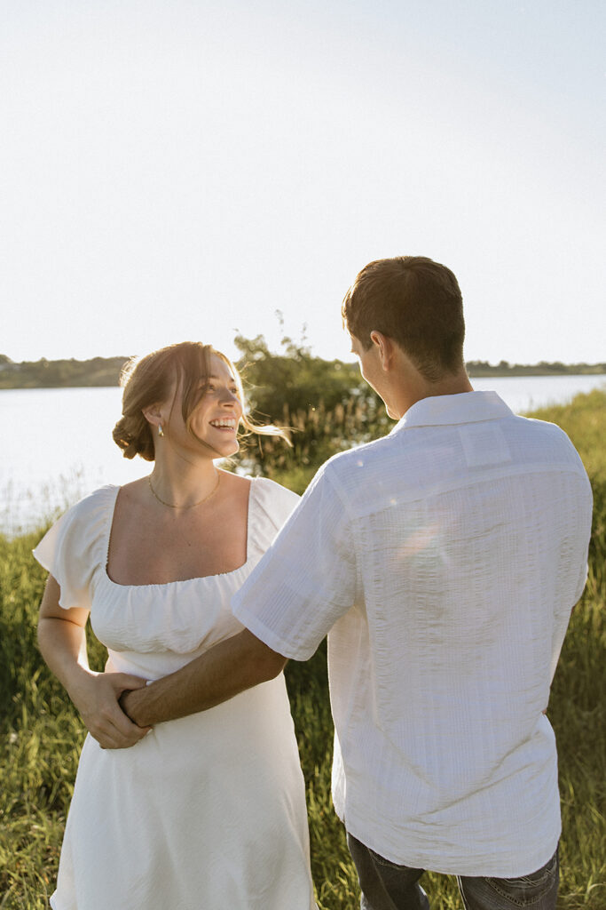 couple smiling at each other during their photoshoot