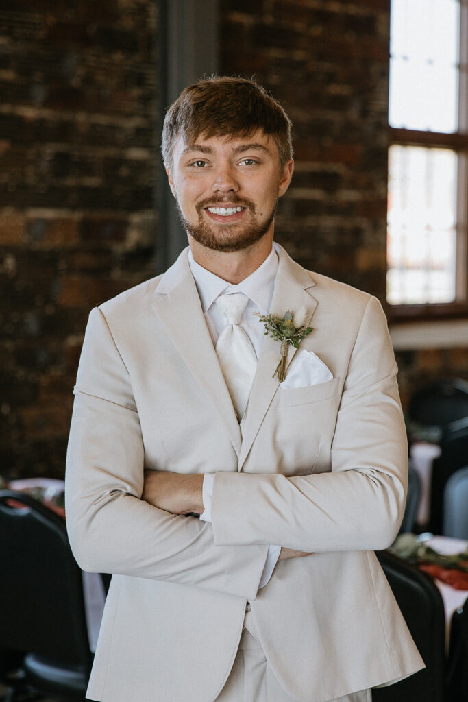 groom getting ready before heading to his first look with the bride