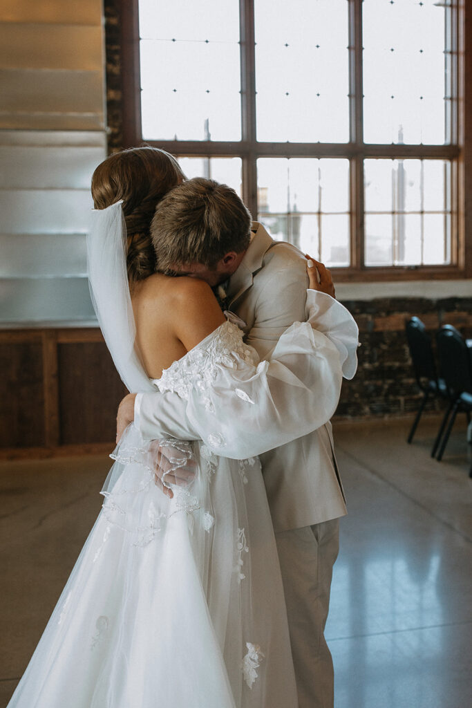 bride and groom hugging after their first look