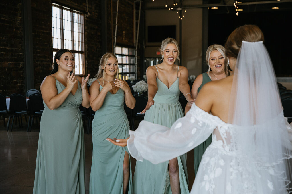 bridesmaids emotional seeing the bride in her wedding dress