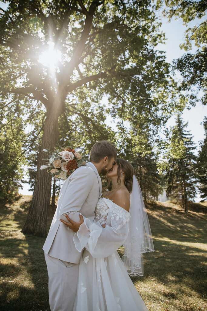 portrait of the bride and groom kissing