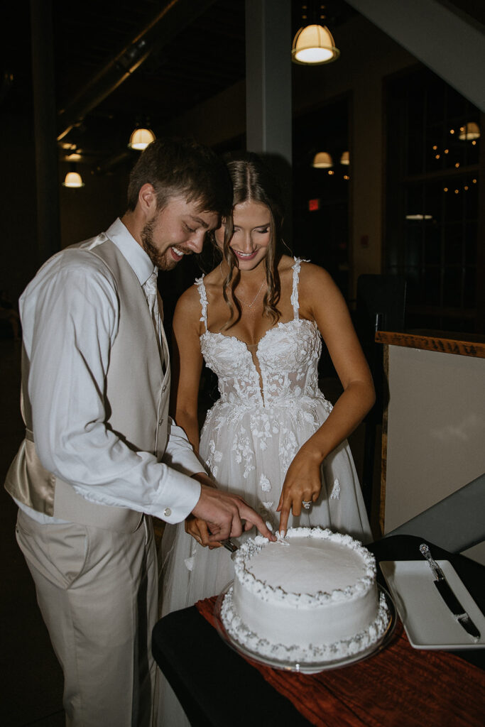 bride and groom cutting their wedding cake