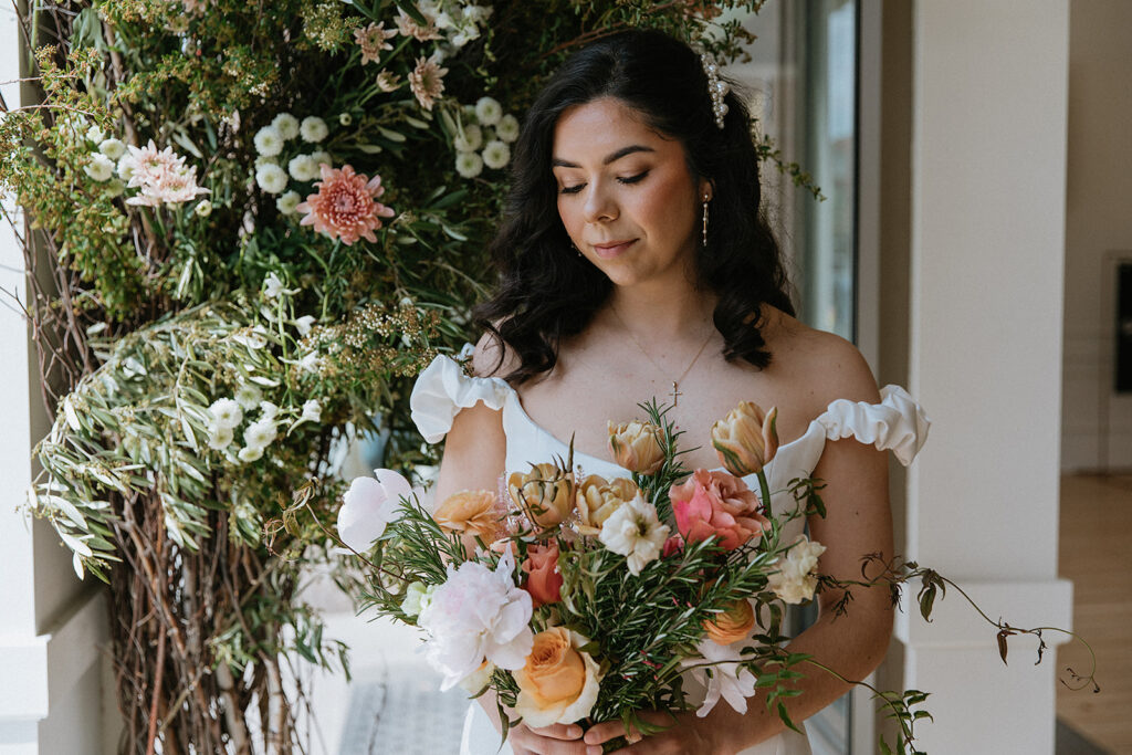 stunning picture of the bride with a vibrant bouquet 