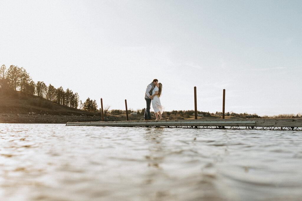 cute picture of the newly engaged couple kissing 