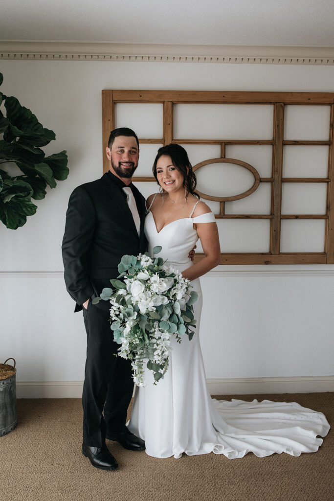 cute picture of the bride and groom smiling at the camera