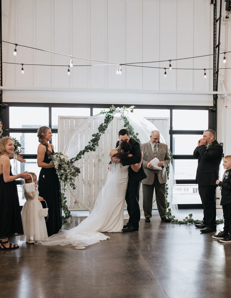 bride and groom kissing after their wedding ceremony