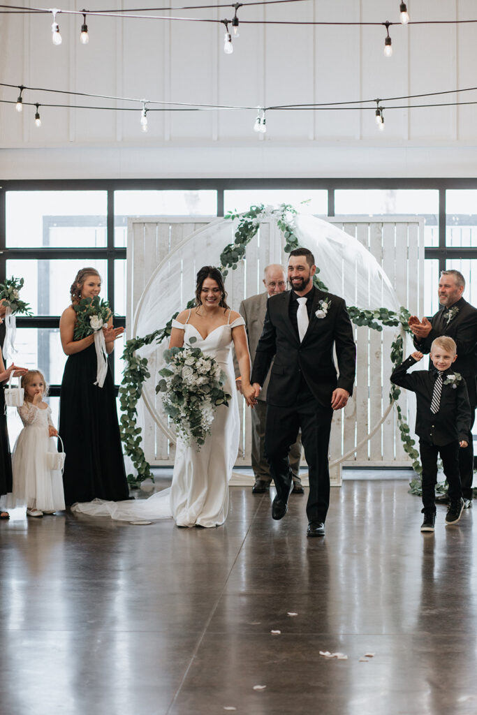 happy newlyweds heading to their wedding reception