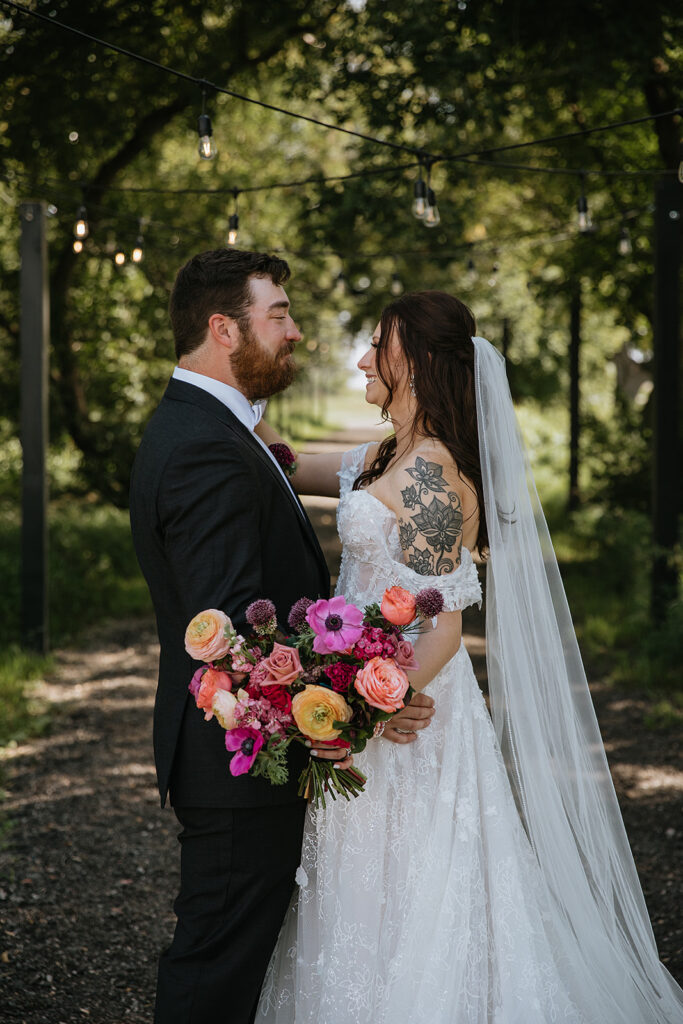 cute portrait of the newlyweds smiling at each other