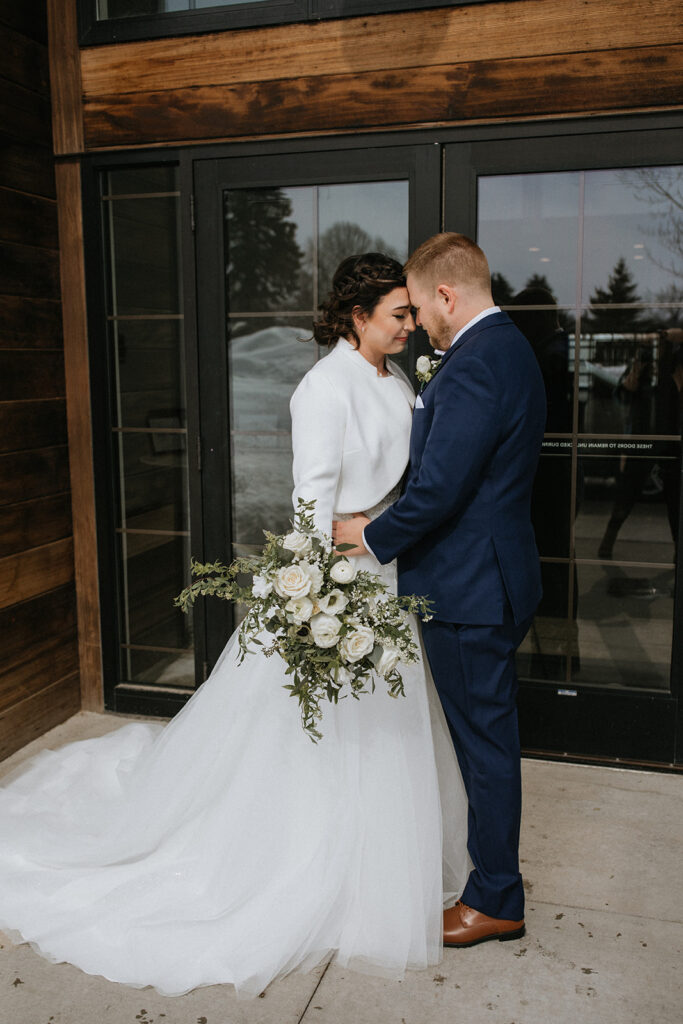 bride and groom smiling at each other during their bridal portraits