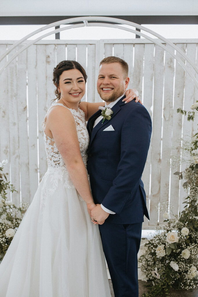 couple smiling at the camera during their photoshoot
