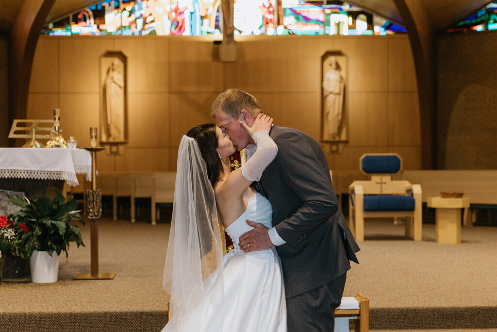 Cute picture of the bride and groom, kissing after their wedding ceremony