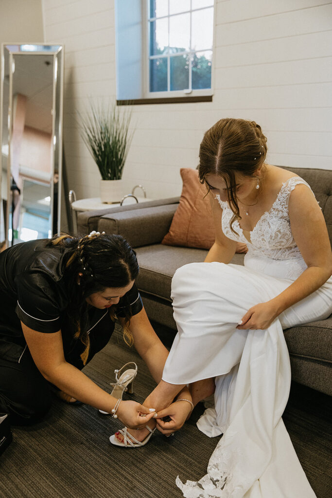Bride putting on her shoes before the ceremony