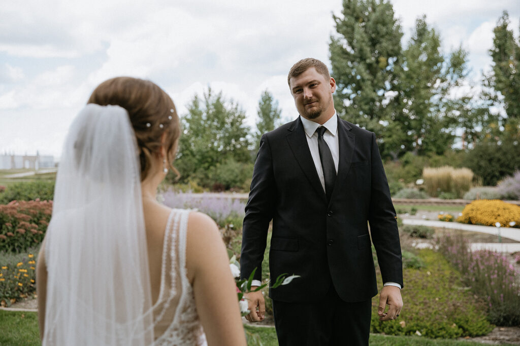groom emotional seeing the bride in her wedding dress