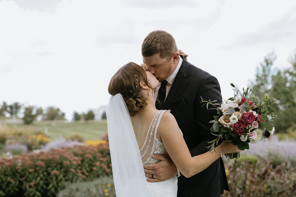 cute picture of the bride and groom kissing after their first look