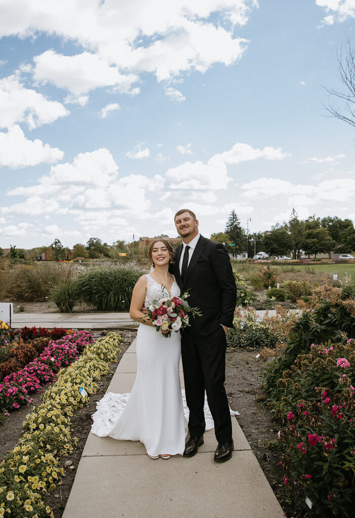 Bride and groom, smiling at the camera during their photoshoot