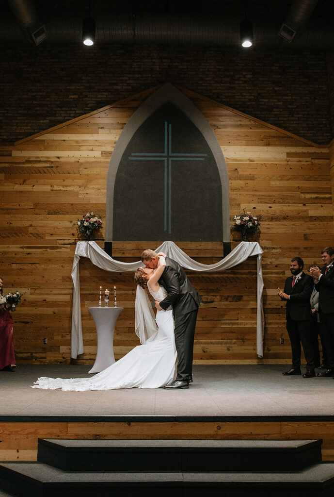 Cute picture of the bride and groom, kissing after their wedding ceremony
