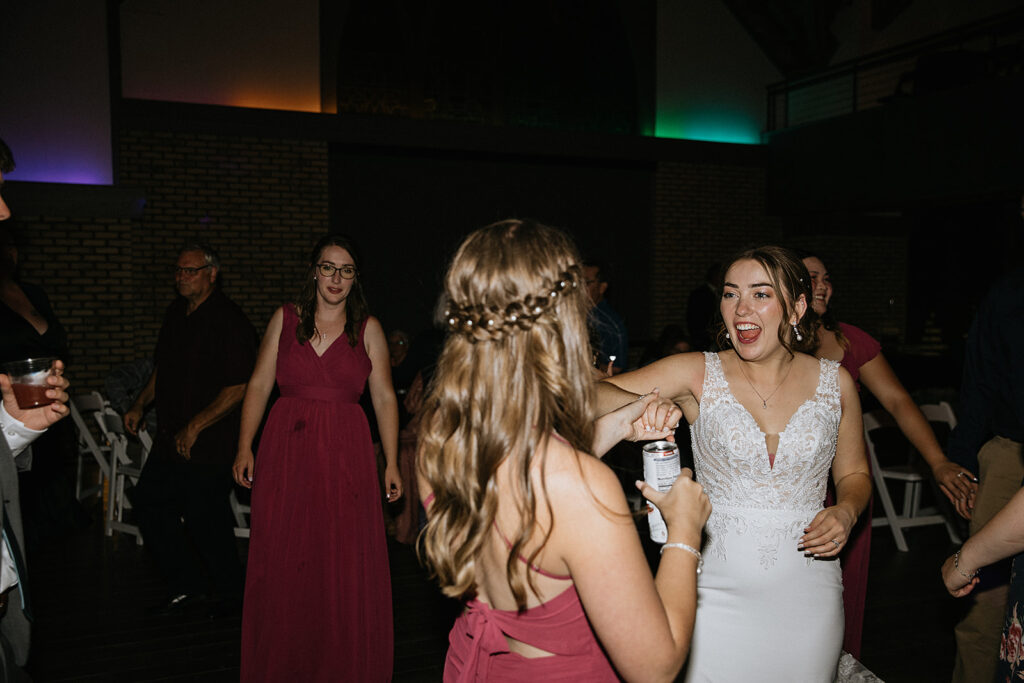 Bride and her bridesmaids dancing at the wedding party