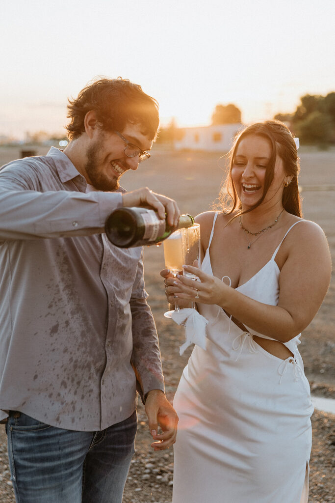 cute couple celebrating their engagement with champagne