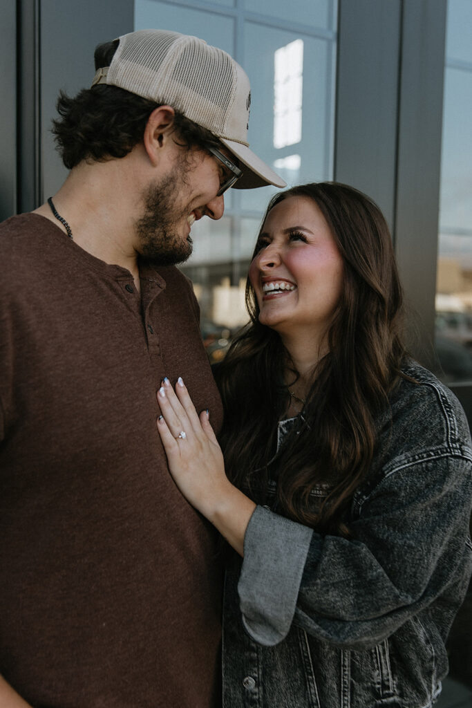 cute couple smiling at each other during their photoshoot