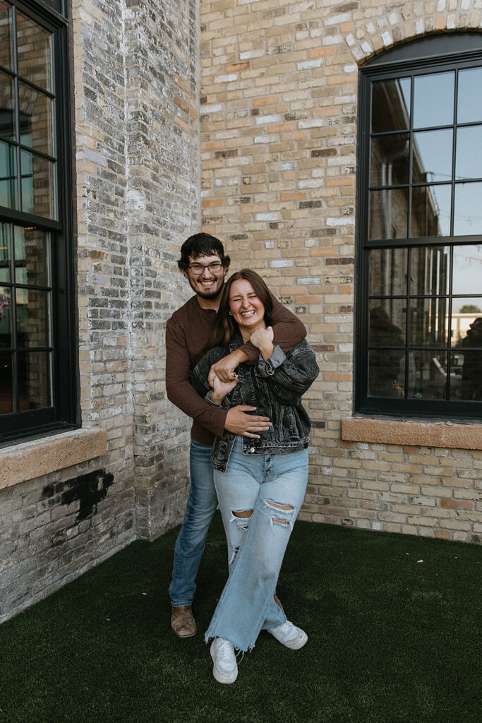 couple playing during their engagement photos