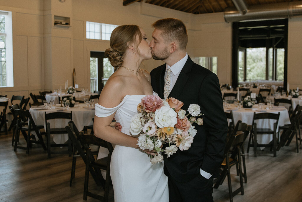 portrait of the bride and groom kissing 