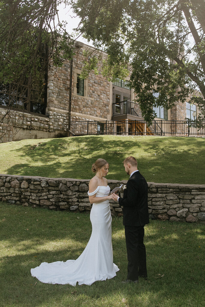 bride and groom reading their vows