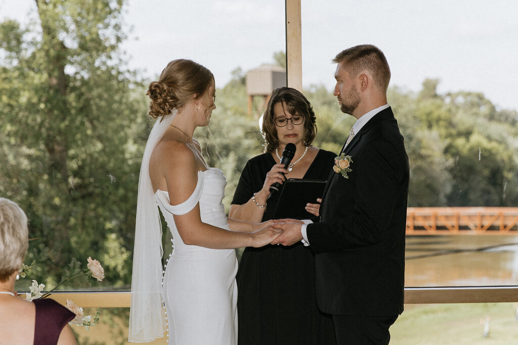 bride and groom holding hands during their ceremony