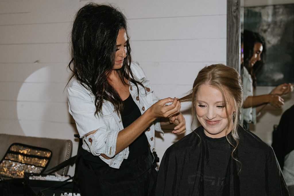 bride getting her hair done for her ceremony
