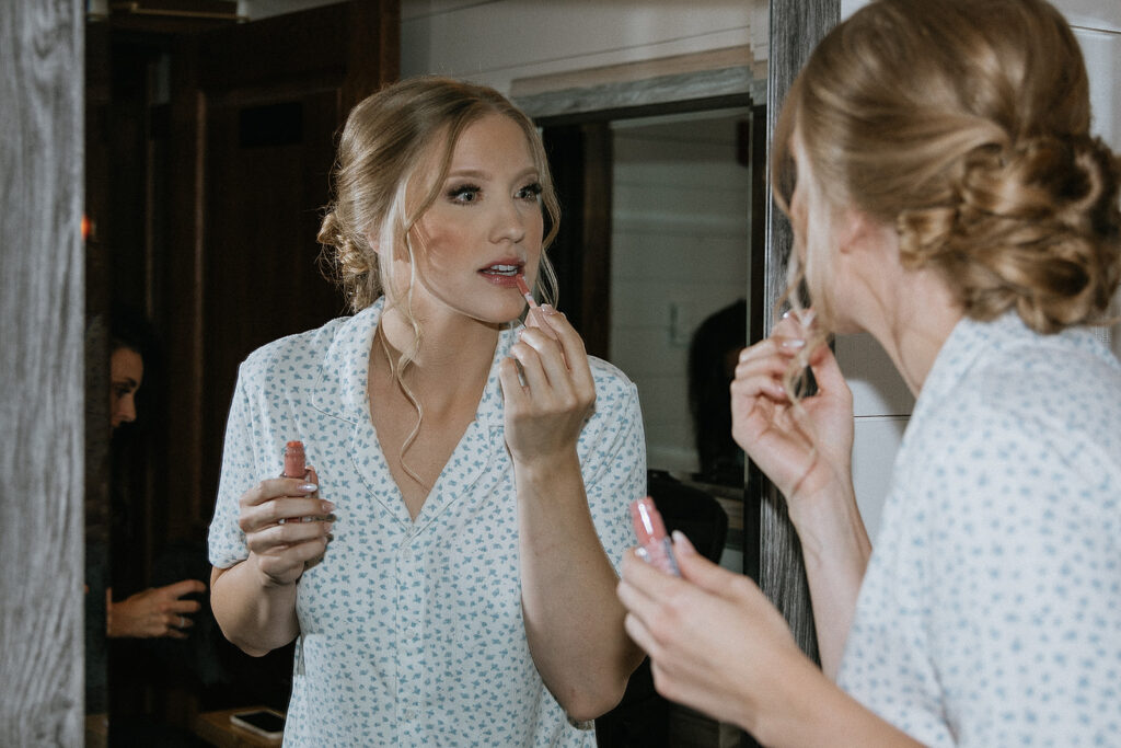 bride doing her makeup before the ceremony