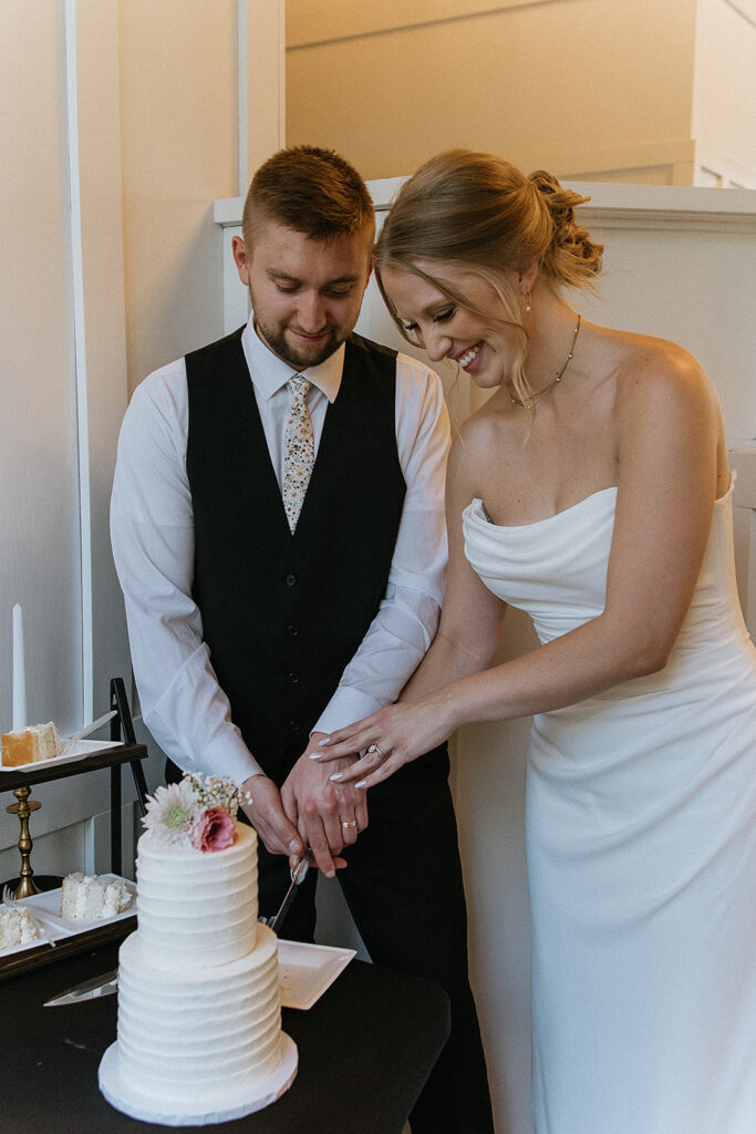 bride and groom cutting their wedding cake