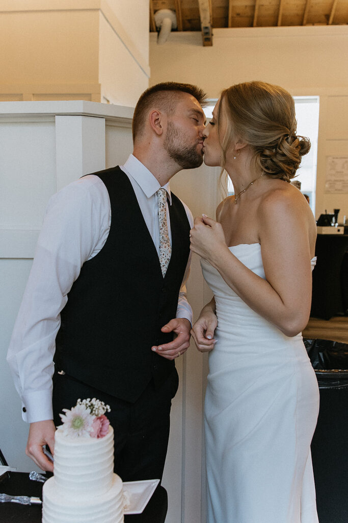 newlyweds trying their wedding cake