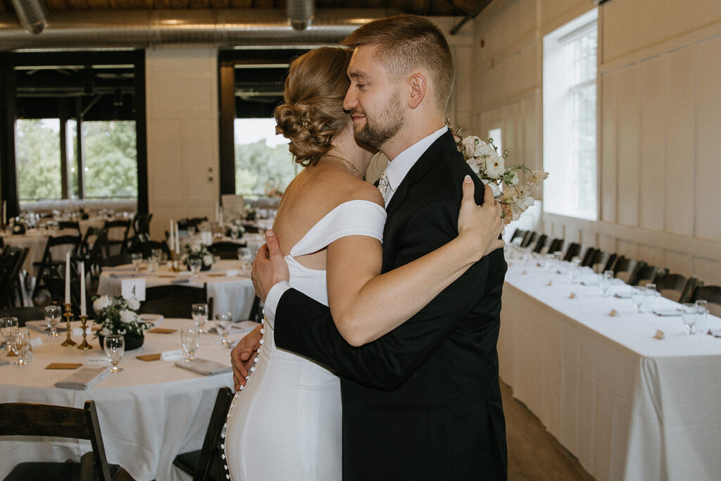 bride and groom hugging after their first look