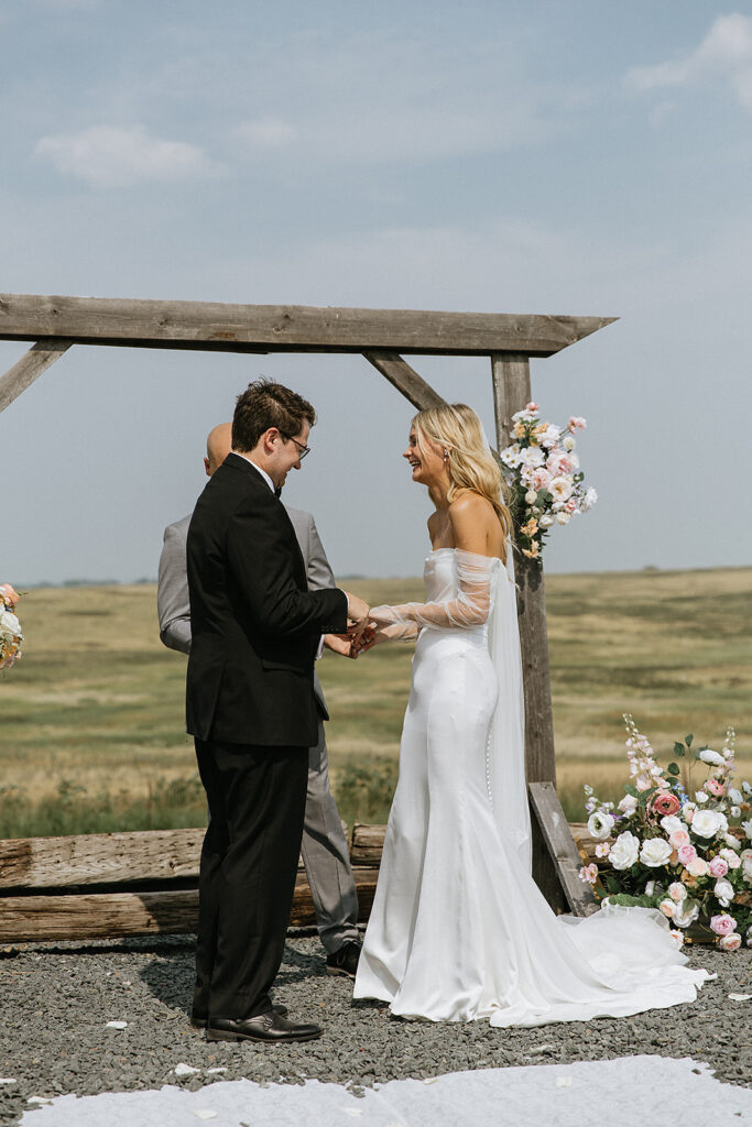 Bride and groom holding hands at their wedding ceremony