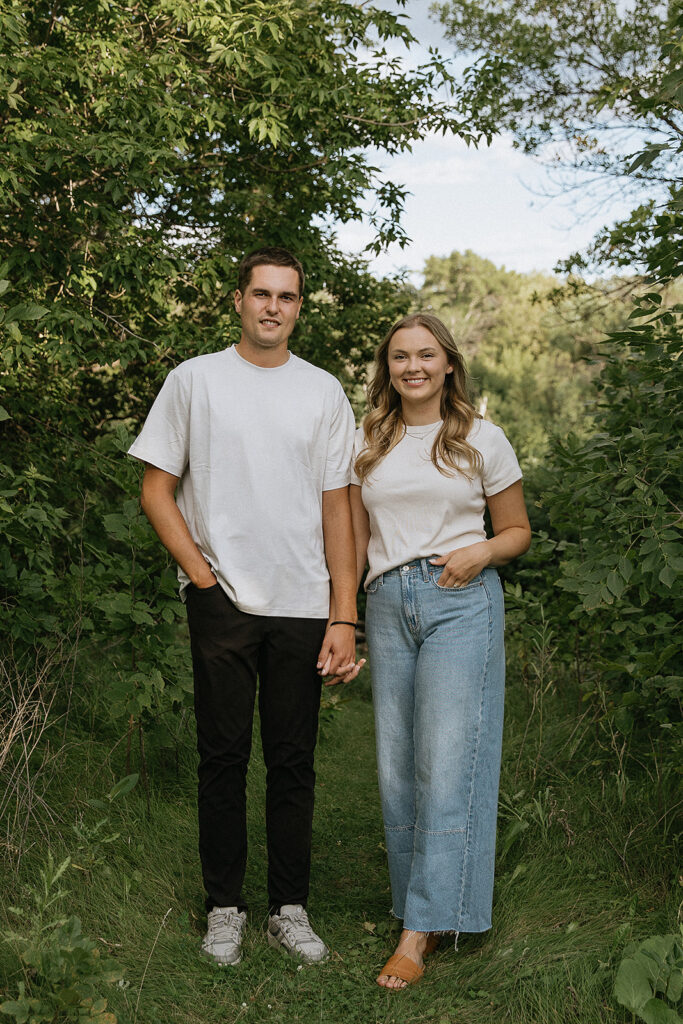 Couple smiling at the camera during their engagement photos