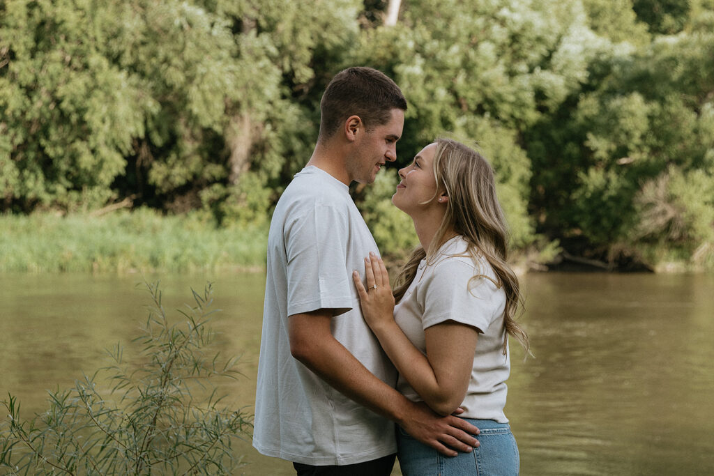 Cute couple smiling at each other during their photoshoot