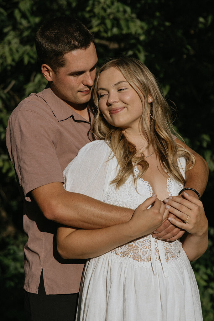 Cute picture of the newly engaged couple smiling at each other