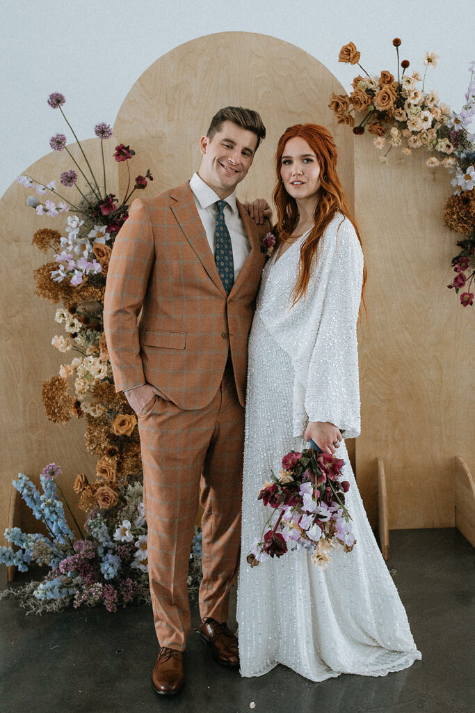 portrait of the bride and groom smiling at the camera during their bridal session