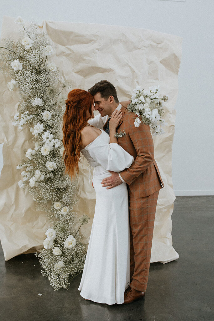 portrait of the bride and groom kissing