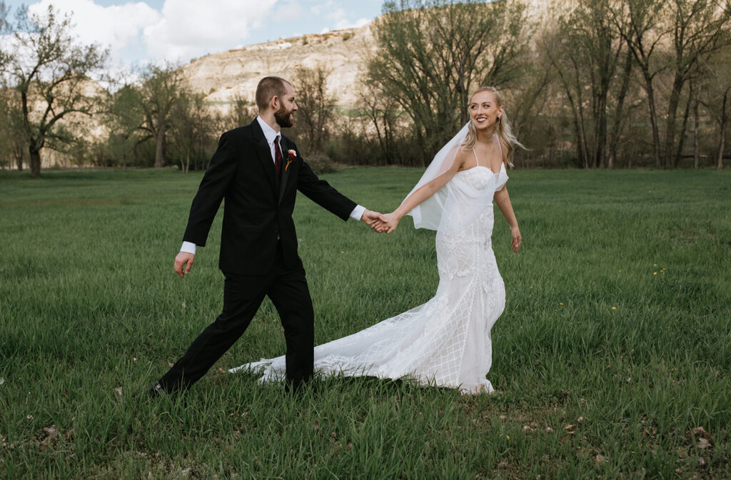 portrait of the bride and groom holding hands during their photoshoot