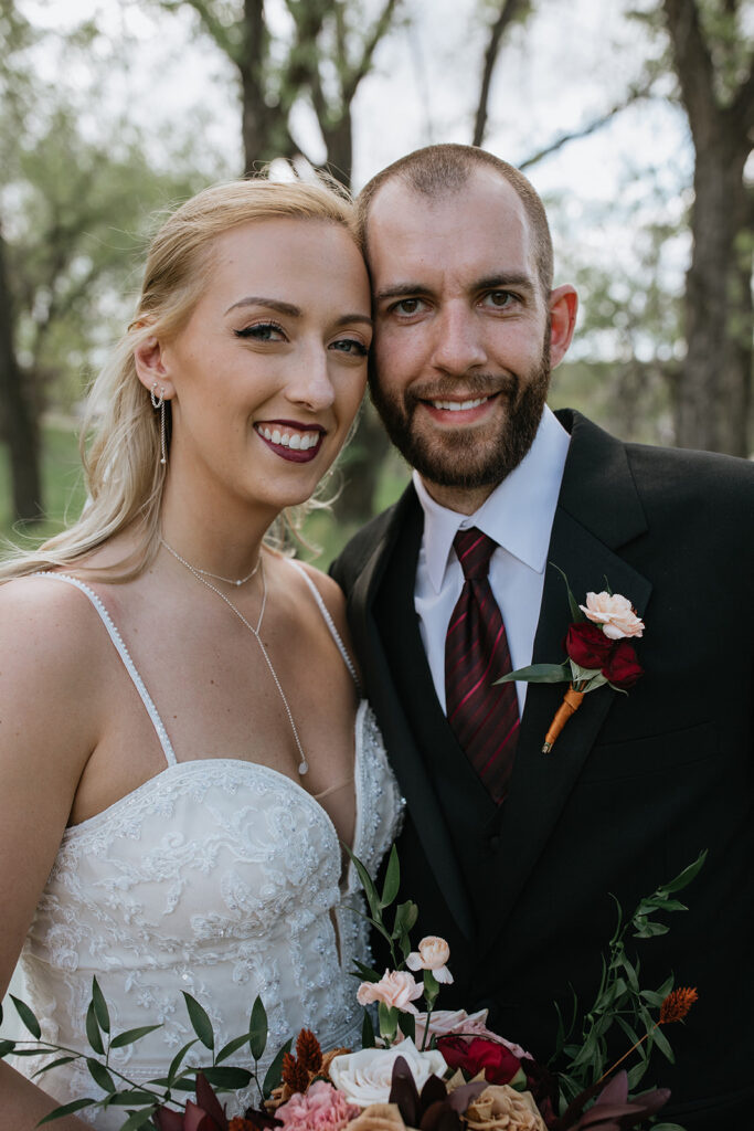 picture of the newlyweds smiling at the camera