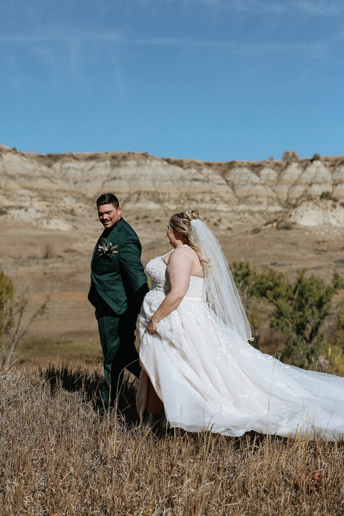 portrait of the bride and groom holding hands