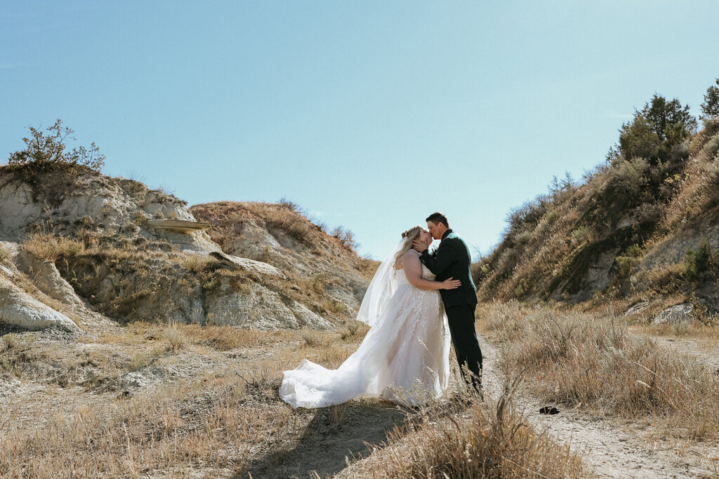 groom kissing the bride on the forehead 